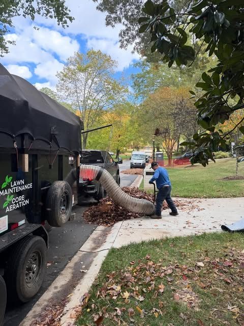 Crew vacuuming leaves into the Jimenez trailer